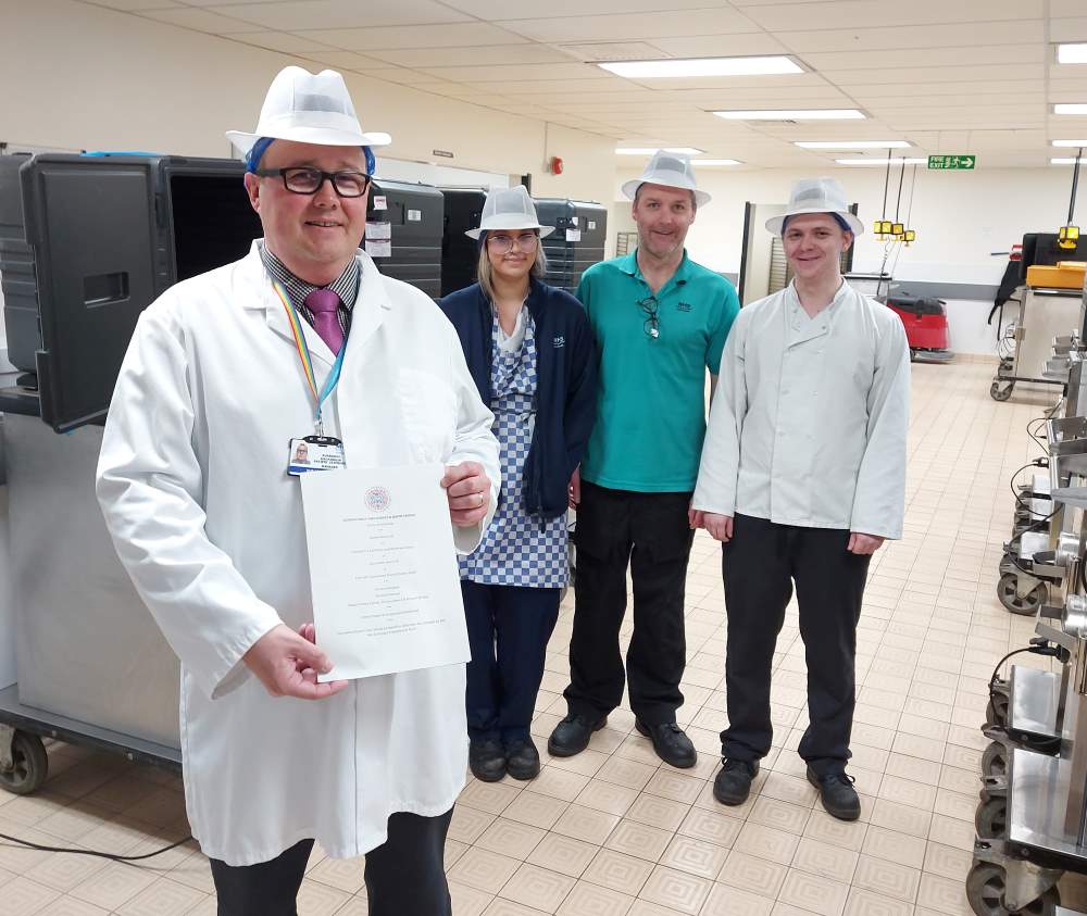 NHS Grampian Coronation Menu, ©NHS Grampian L-R: Ruaraidh McKinnon, Caitlin Angus (cook), Steven Tait (team leader), and Bradley Gillespie (cook) in the production kitchen at Royal Cornhill Hospital