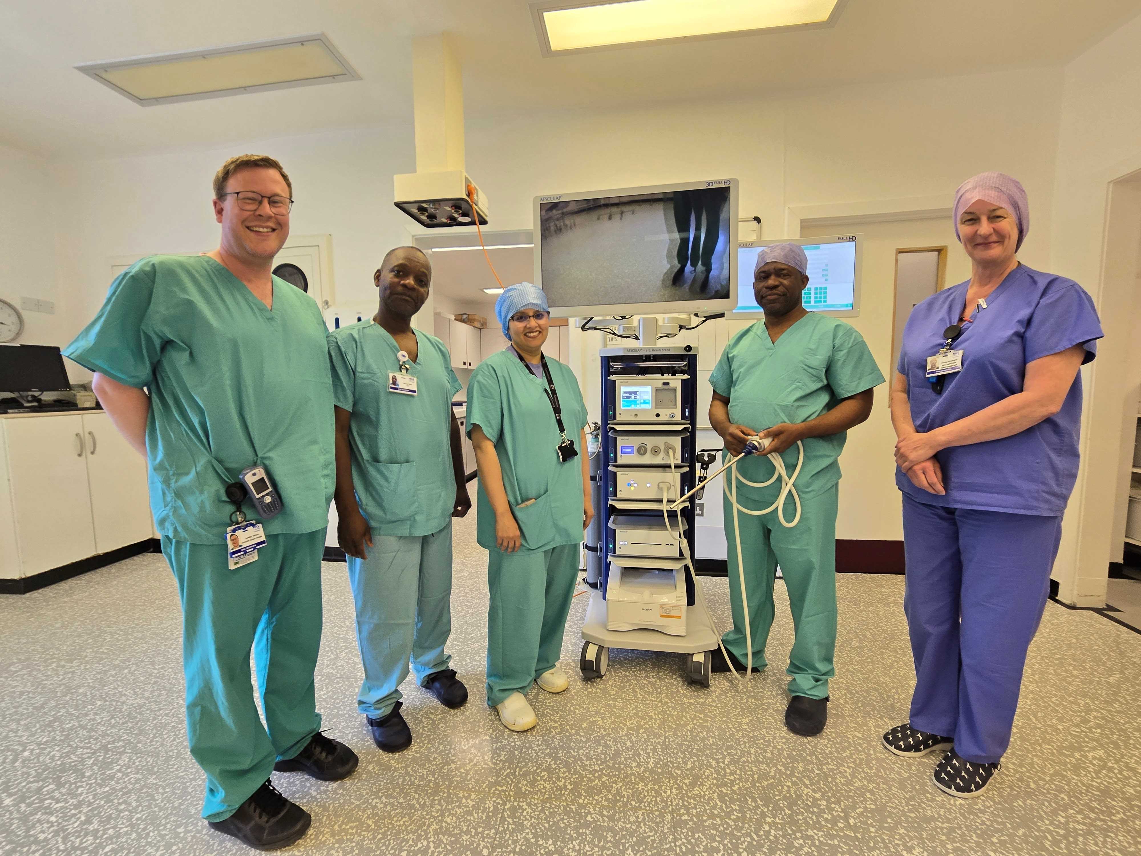 Theatre team at Dr Gray's, ©NHS Grampian The group photograph taken in theatres at Dr Gray’s Hospital includes (from left to right): Senior Staff Nurse Daniel Wood, Operating Department Practitioner Nhamo Daka, Consultant Dr Farha Fatima, Staff Nurse Alphonsus Ameh and Senior Staff Nurse Hazel Stockwell.
