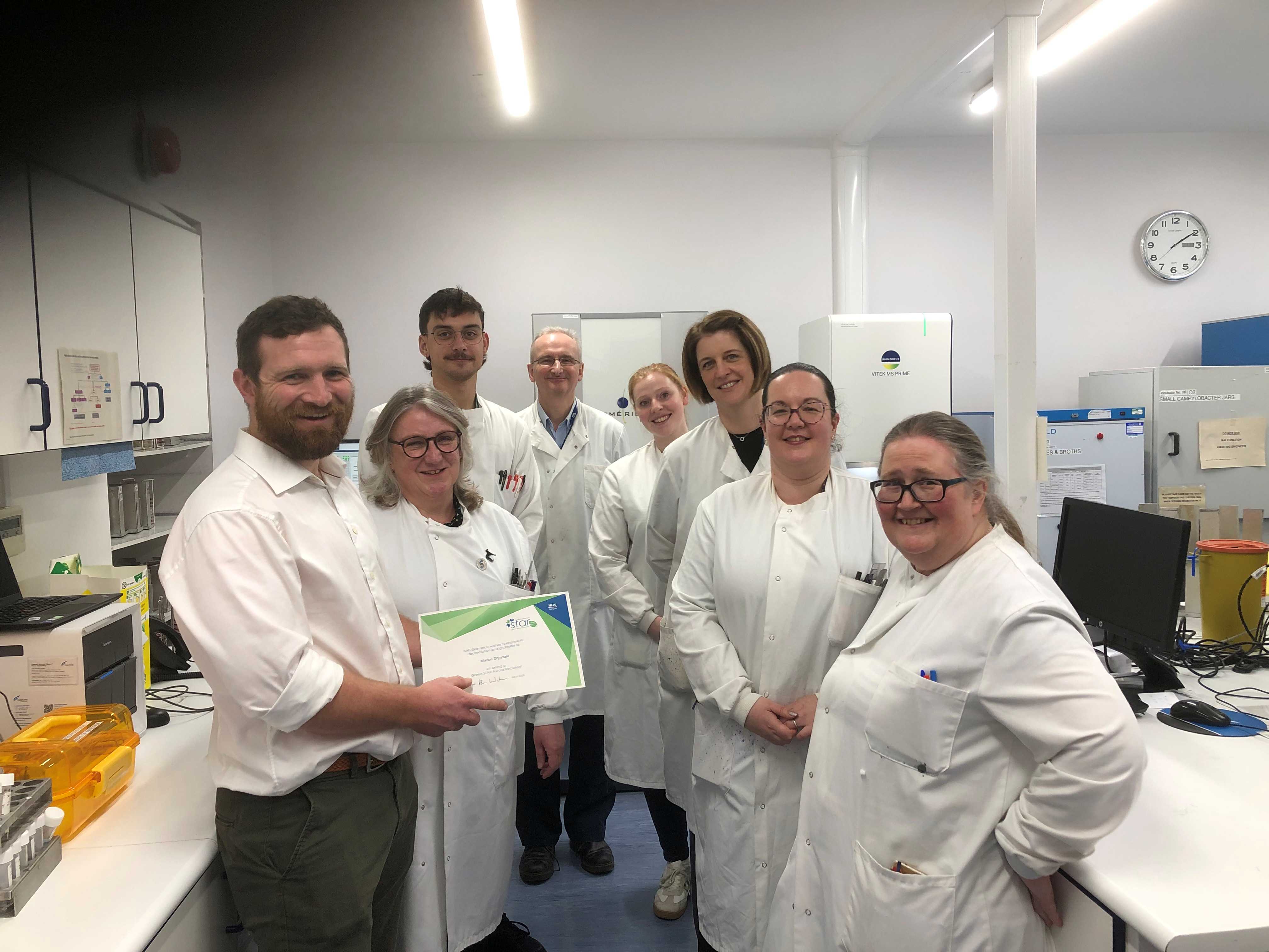Michael (far left) and Marion (far right) with members of the labs team at Aberdeen Royal Infirmary.